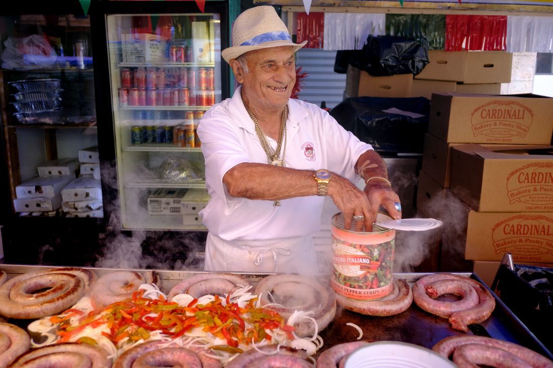 Vincenzo gets the sausages ready at his booth. He has been working the festival for over 50 years. The Feast of San Gennaro in the Little Italy neighborhood of Manhattan. Saturday 09 17 2022  New York, NY.  © Aristide Economopoulos for WNYC